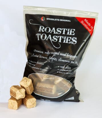 The Roastie Toastie product in its bag with four briquettes stacked beside the bag